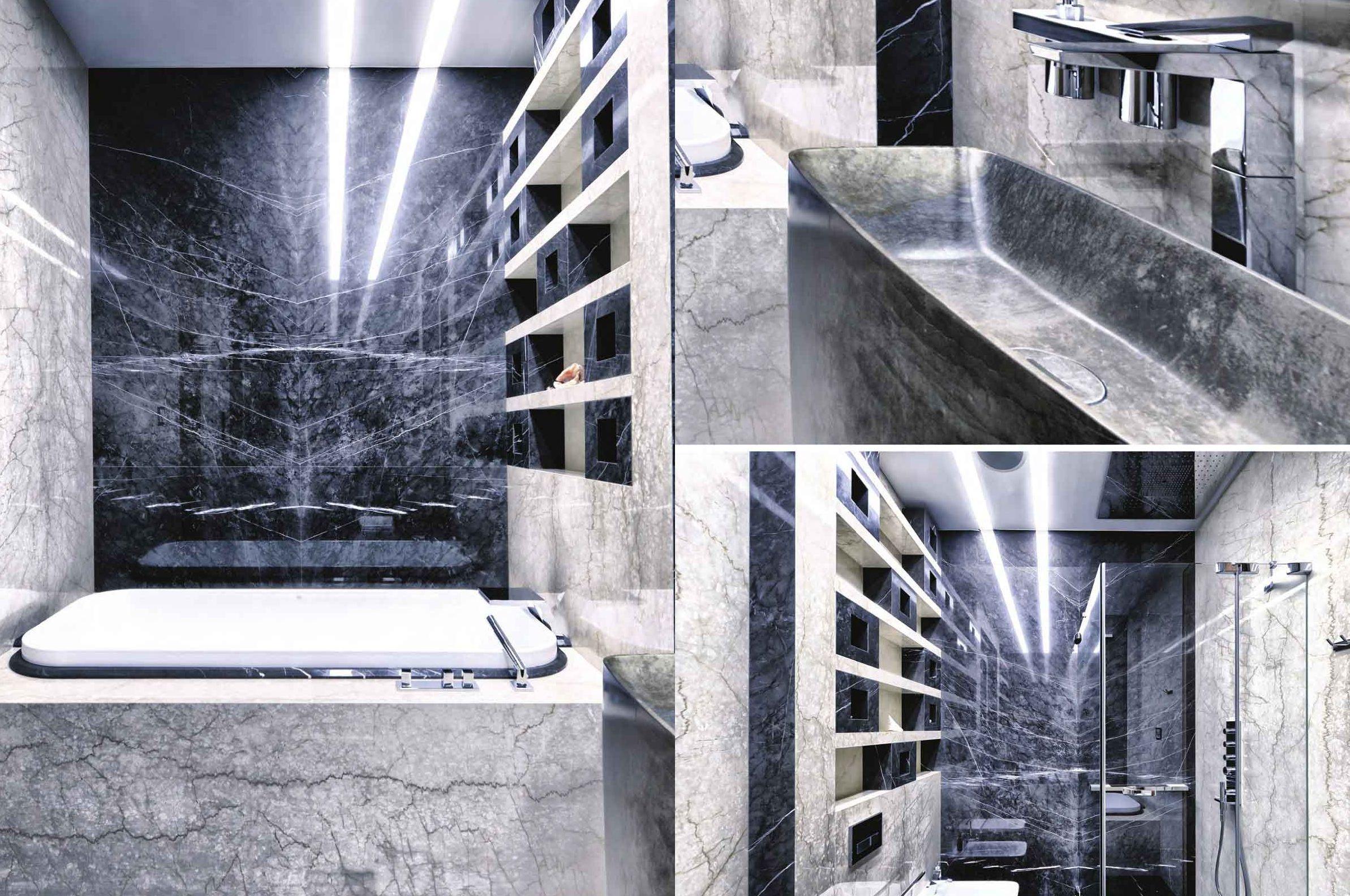 Bagno in marmo grigio venato con vasca incassata e nicchie retroilluminate